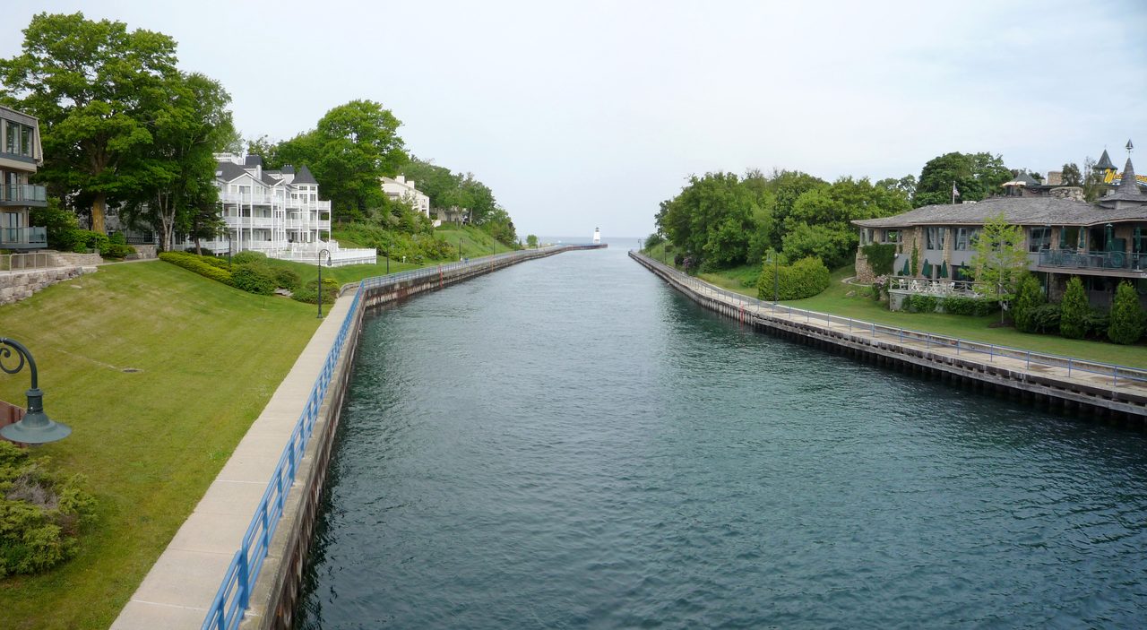 Charlevoix South Pier Lighthouse with pine trees on a summer day